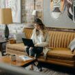 woman using laptop while sitting on chair